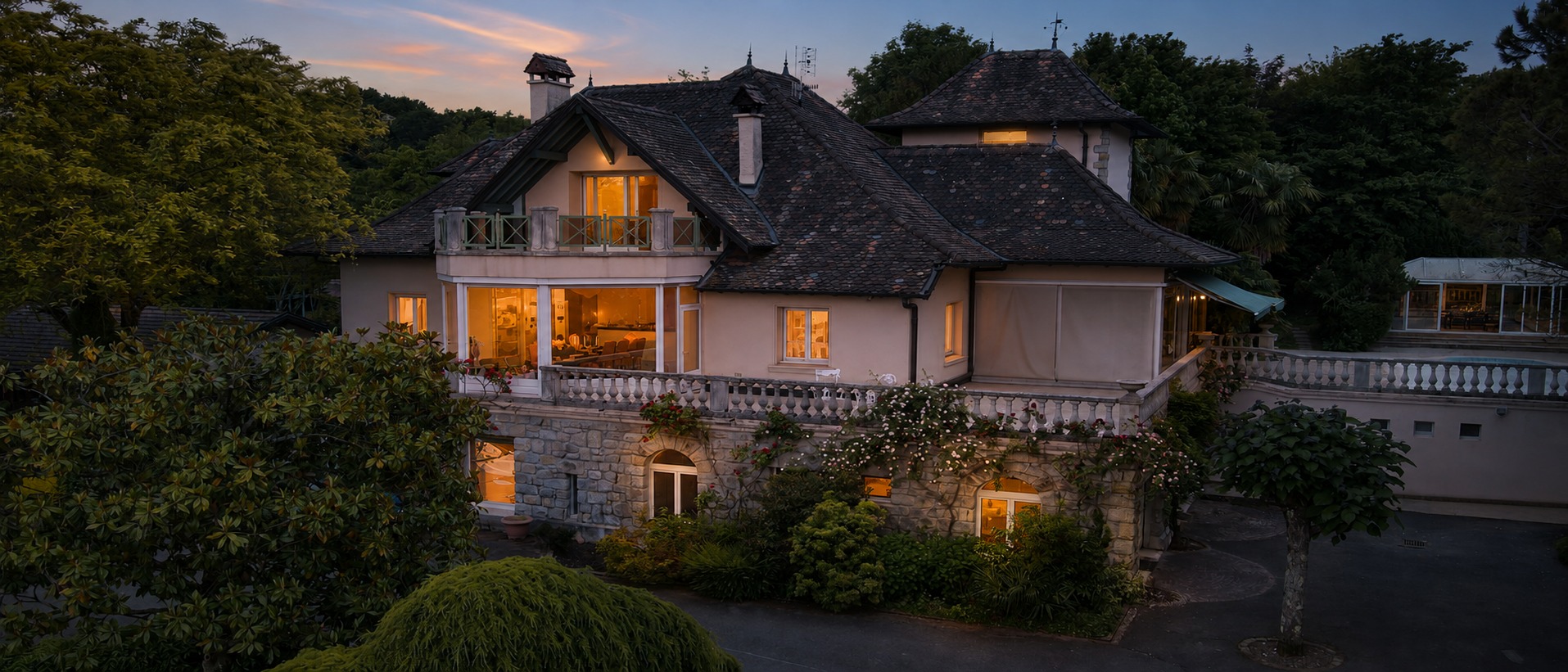 Clos des Savoyances, with warm windows and garden greenery at dusk. Artistically enhanced from the original photograph.